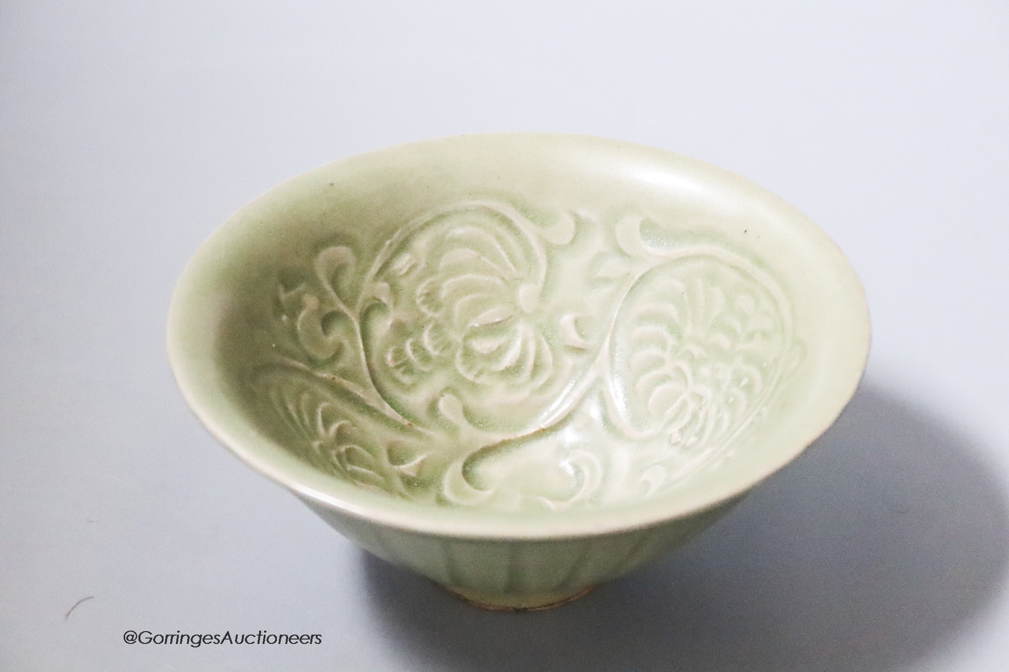 A Chinese carved celadon bowl, diameter 12cm